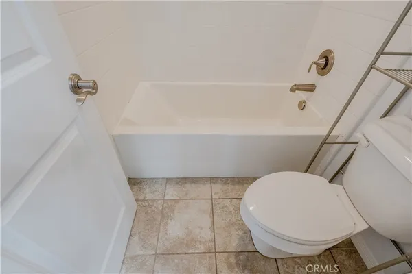 a bathroom with a toilet and a bathtub