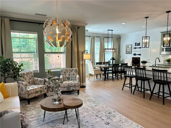 a living room with furniture dining table and a large window