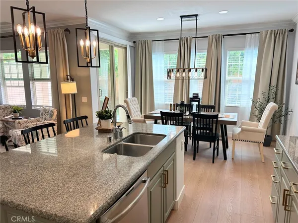 a kitchen with granite countertop a sink a counter top space and stainless steel appliances