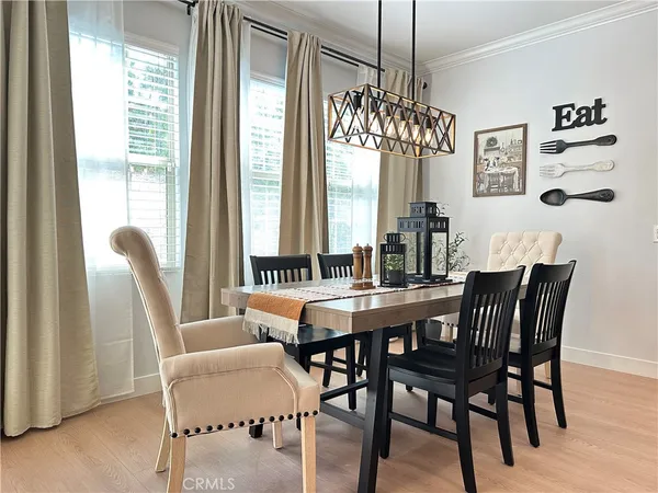 a view of a dining room with furniture window and wooden floor