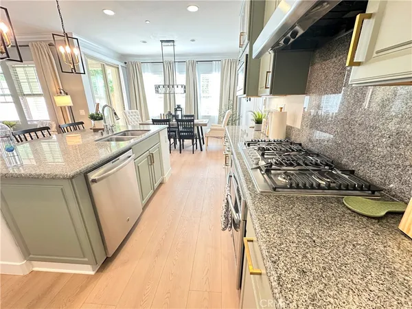 a kitchen with sink a stove and chairs