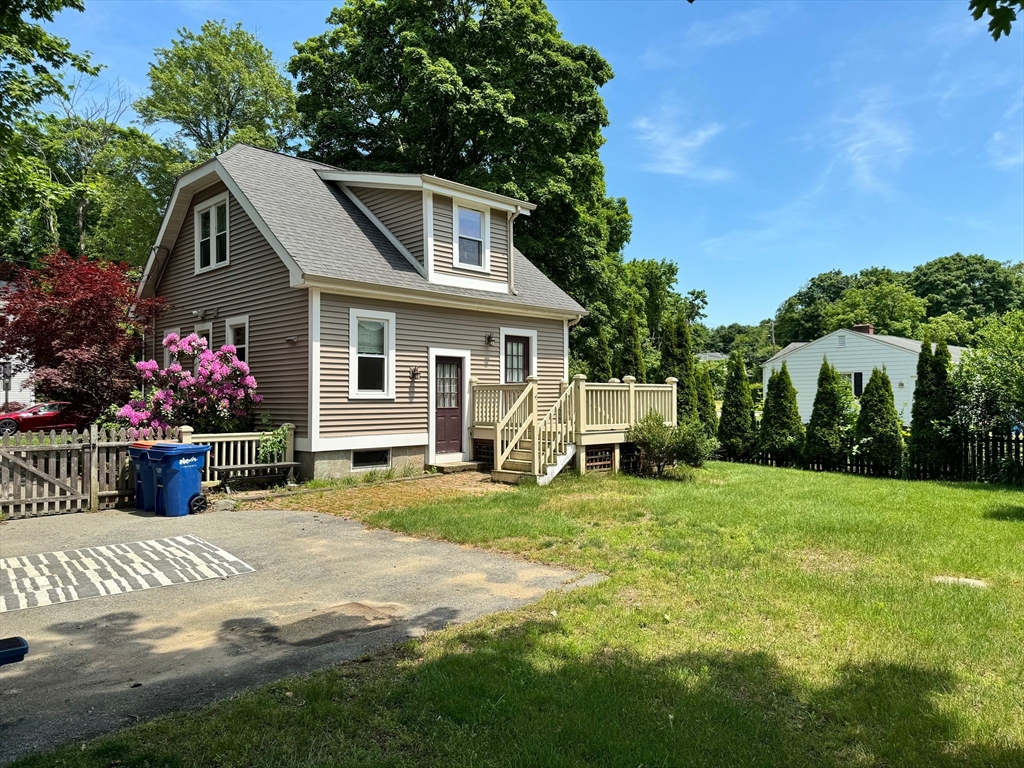 a view of a house with backyard and sitting area