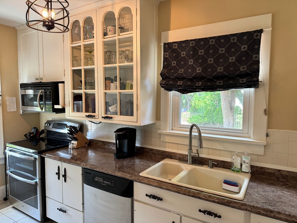 14 Field Street Seekonk, MA 02771 - Photo 9 of 26 a kitchen with stainless steel appliances a sink a stove and a window