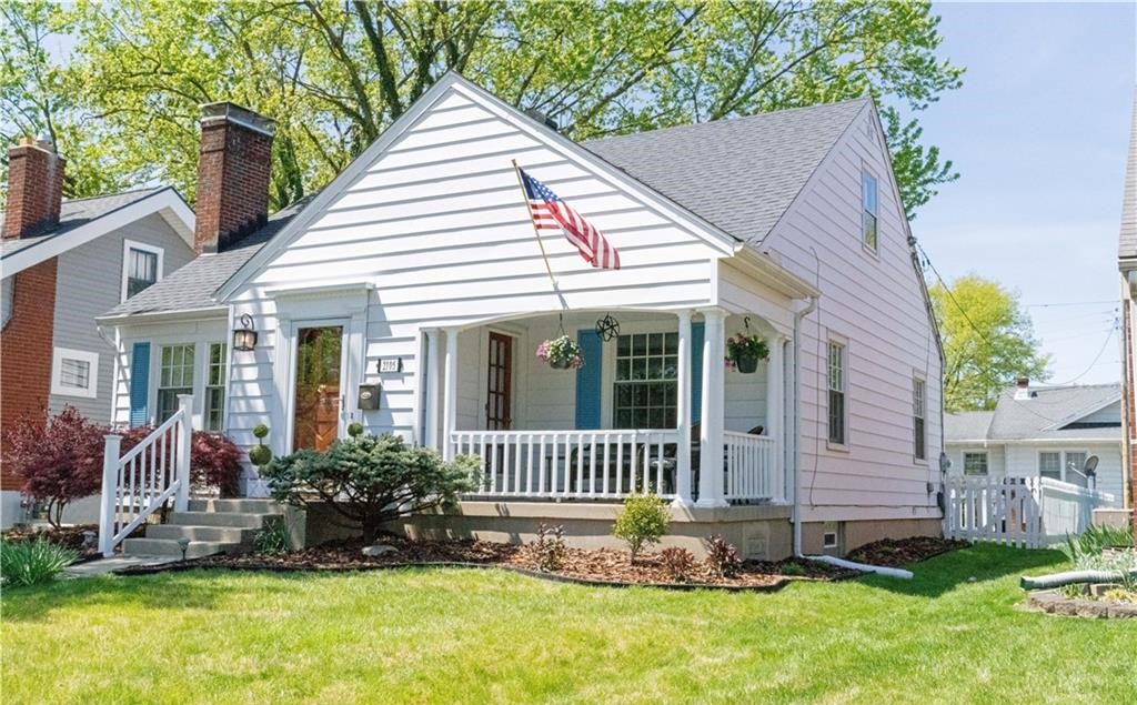 This charming home features a welcoming covered porch, perfect for enjoying sunny afternoons.