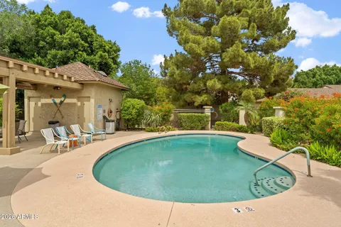 a view of a swimming pool with outdoor seating