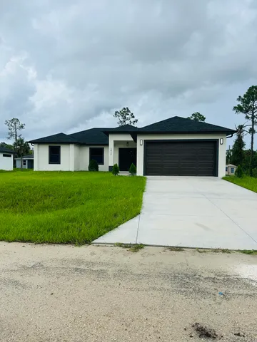 a front view of house with yard and green space