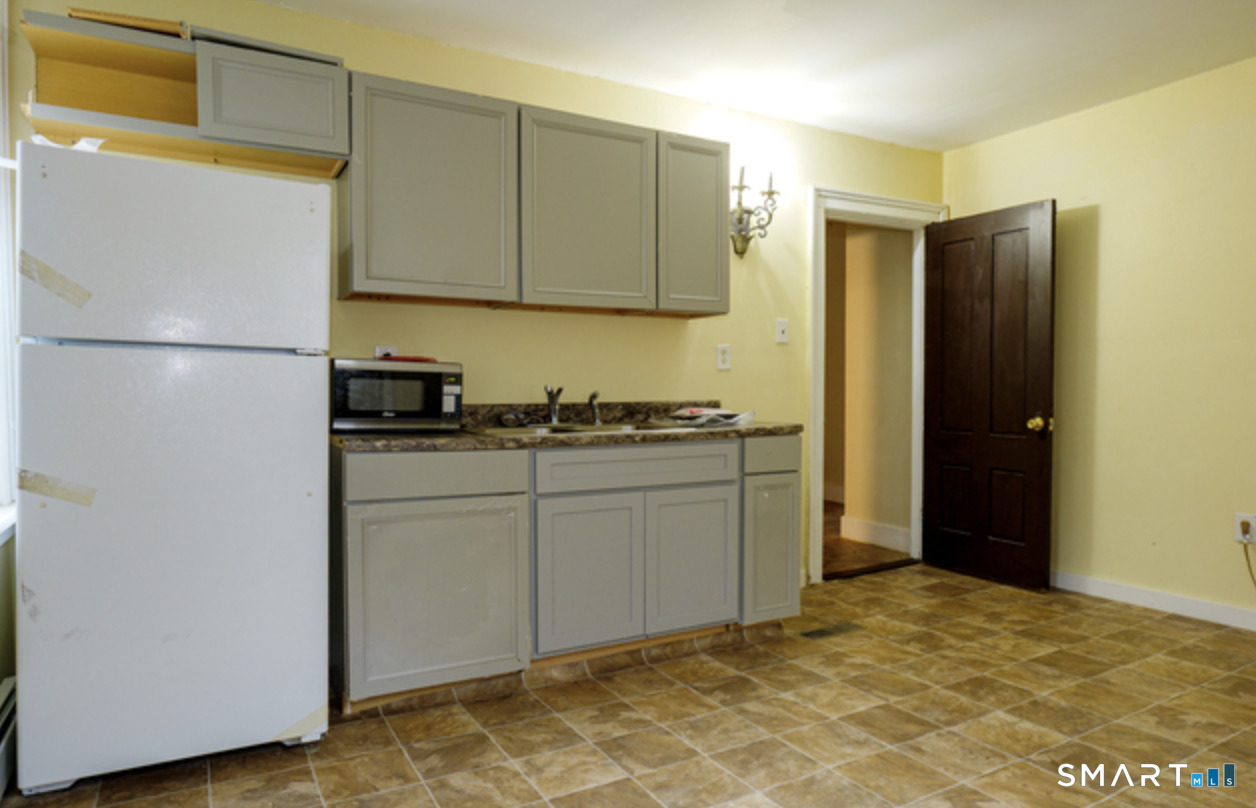 30 Main Street Plainfield, CT 06332 - Photo 2 of 14 a kitchen with a refrigerator and cabinets