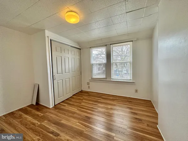 a view of a room with wooden floor and window