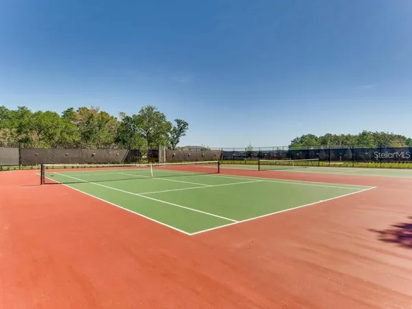 a view of a field with trees in the background