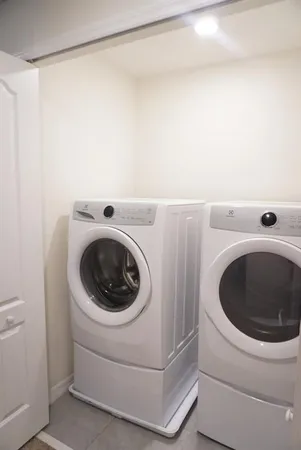 a view of a storage & utility room with washing machine