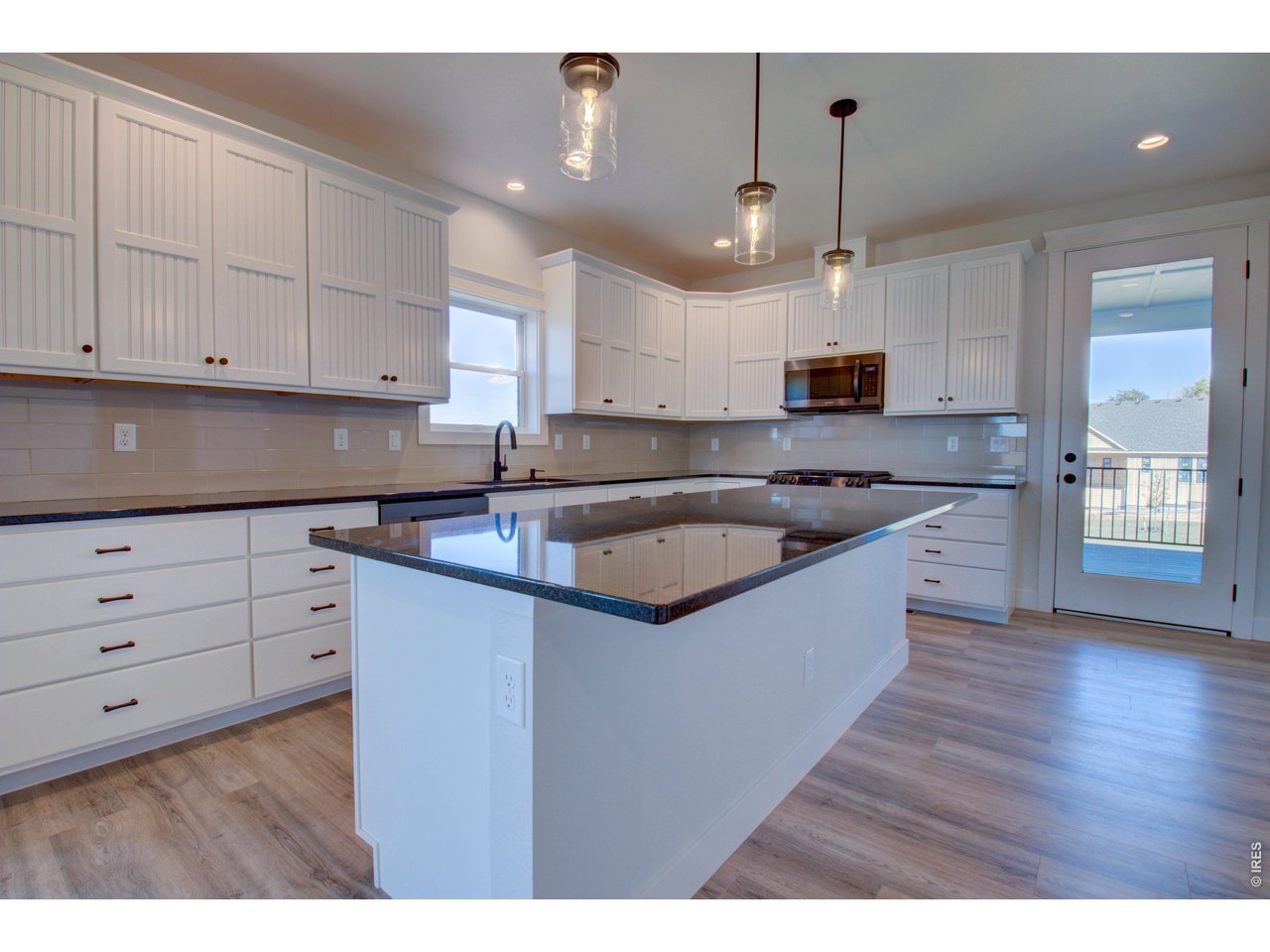 5705 2nd Road Greeley, CO 80634 - Photo 16 of 46 There's lots of useable striking black quartz countertop space in the kitchen