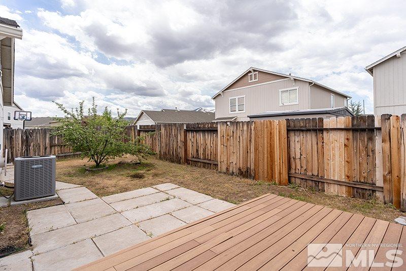7725 Tulear Street Reno, NV 89506 - Photo 15 of 16 a view of a wooden deck besides a house