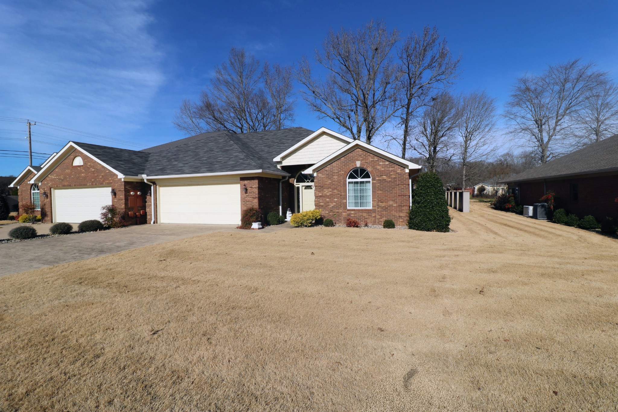 a view of a house with a yard covered in snow