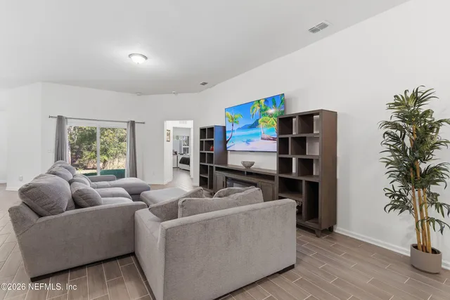 a living room with furniture and a potted plant