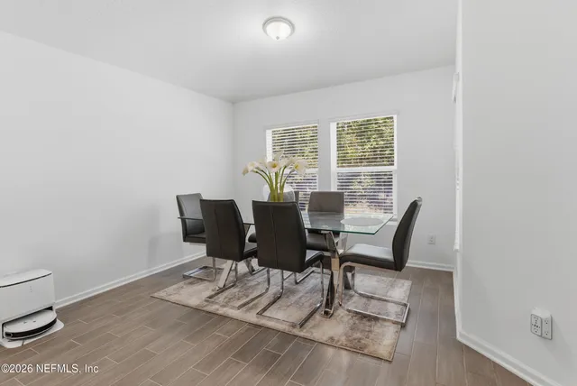 a view of a dining room with furniture and wooden floor