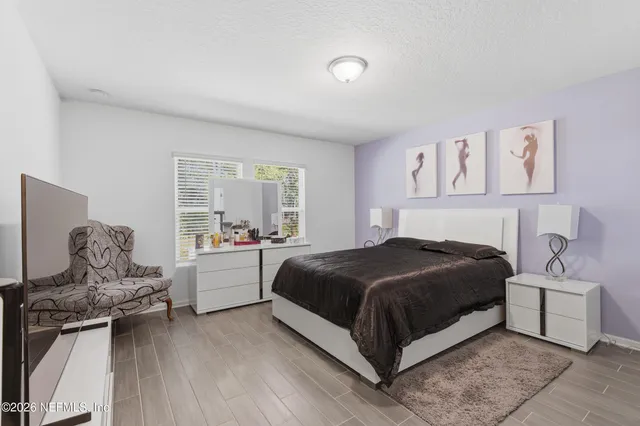 a bedroom with a bed and a mirror