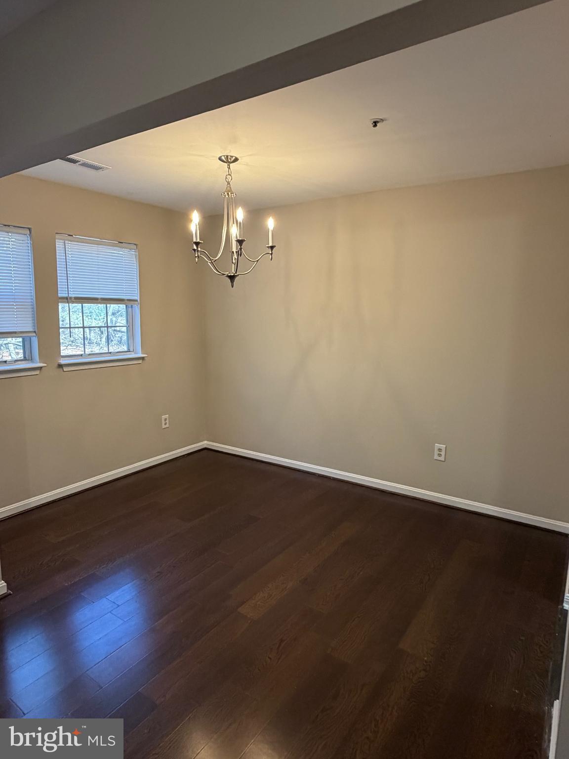 8571 Falls Run Road, Unit F Ellicott City, MD 21043 - Photo 1 of 15 a view of an empty room with wooden floor and a bookshelf