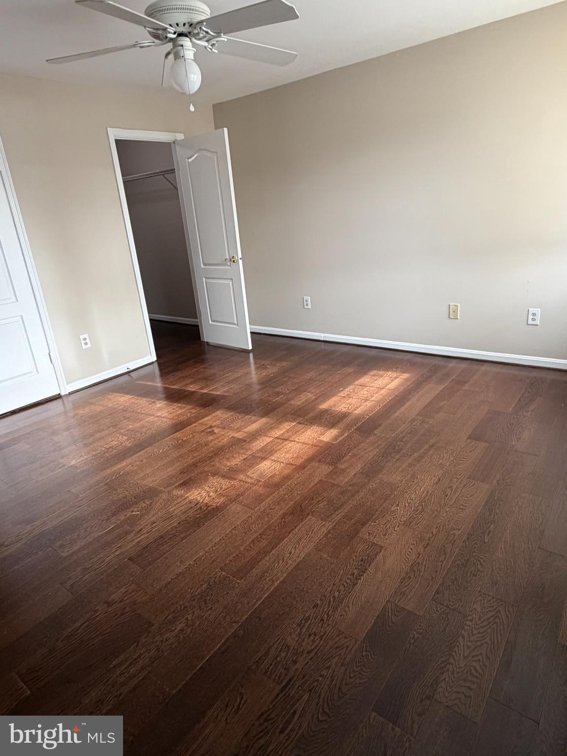 8571 Falls Run Road, Unit F Ellicott City, MD 21043 - Photo 13 of 15 an empty room with wooden floor and door