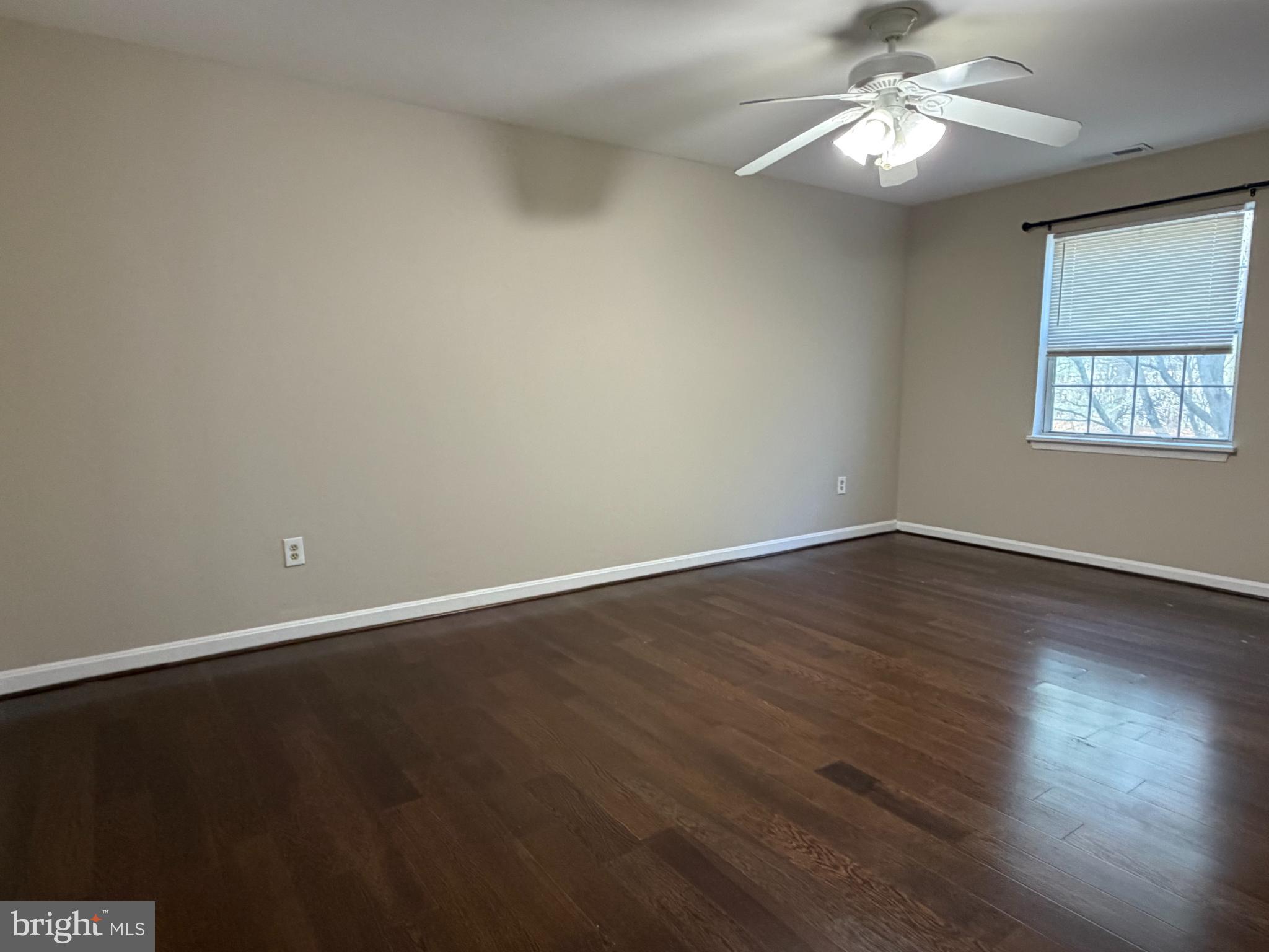 8571 Falls Run Road, Unit F Ellicott City, MD 21043 - Photo 9 of 15 wooden floor in an empty room with a window