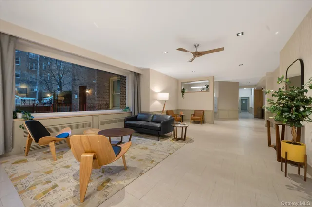 a living room with furniture and a potted plant