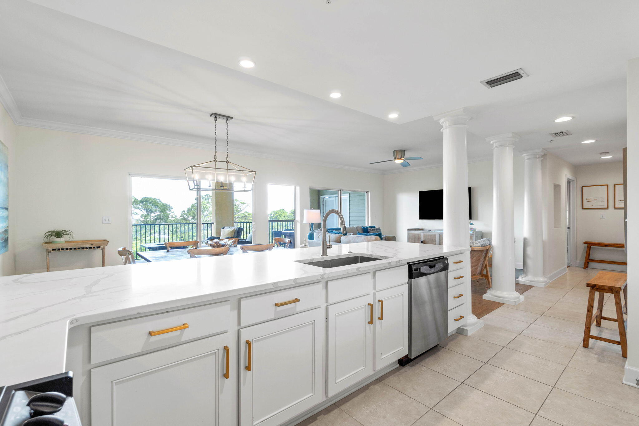 1732 West County Highway 30A, Unit 402 Santa Rosa Beach, FL 32459 - Photo 11 of 32 a kitchen with kitchen island granite countertop a sink and white cabinets