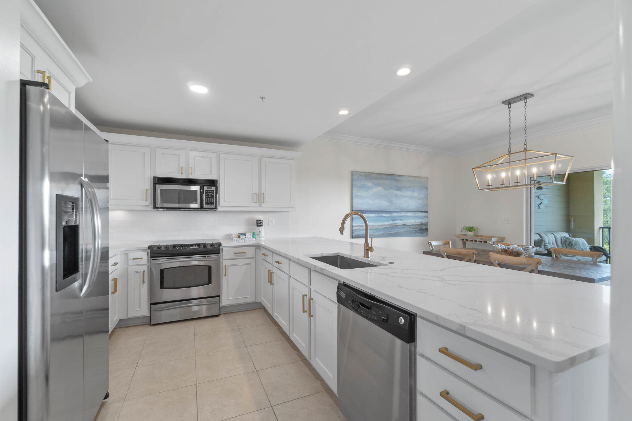 1732 West County Highway 30A, Unit 402 Santa Rosa Beach, FL 32459 - Photo 12 of 32 a large kitchen with stainless steel appliances granite countertop a sink dishwasher a stove and a refrigerator with wooden floor
