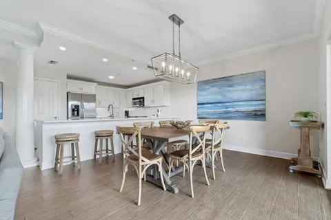 a view of a dining room with furniture wooden floor and chandelier