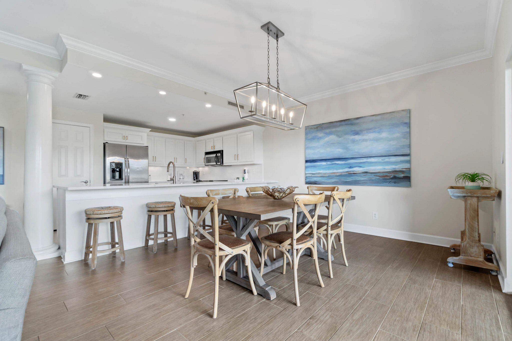 1732 West County Highway 30A, Unit 402 Santa Rosa Beach, FL 32459 - Photo 13 of 32 a view of a dining room with furniture wooden floor and chandelier