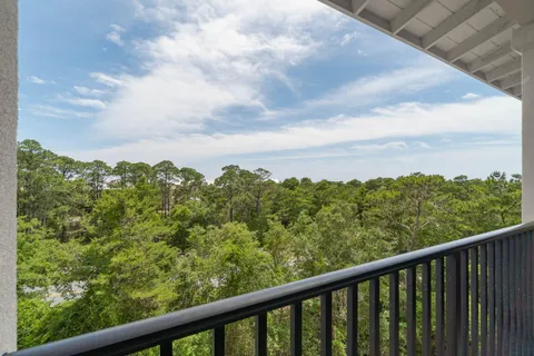 a view of a green field with sky from balcony