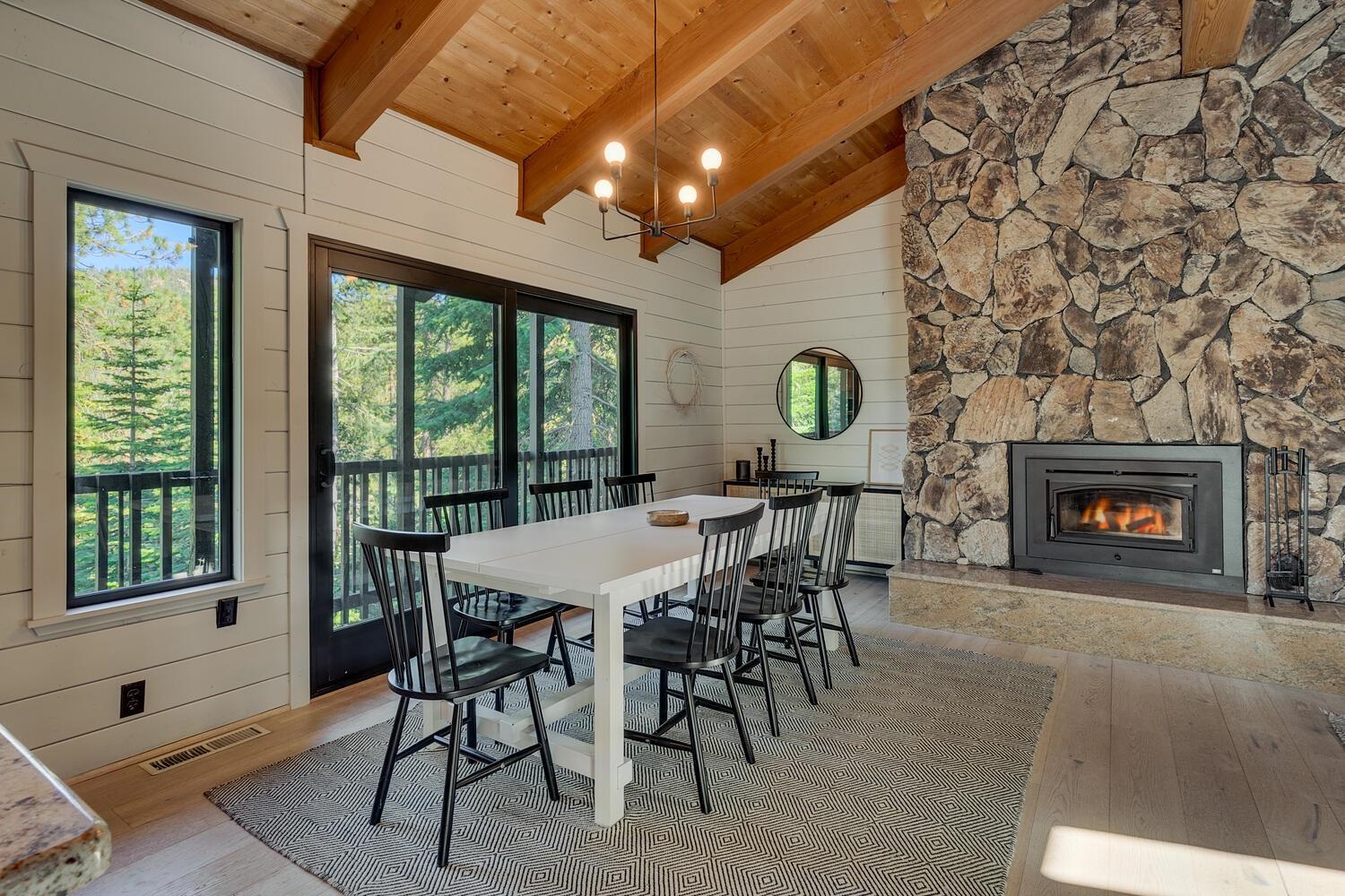 126 Tiger Tail Road Olympic Valley, CA 96146 - Photo 4 of 28 a dining room with furniture a fireplace and a chandelier