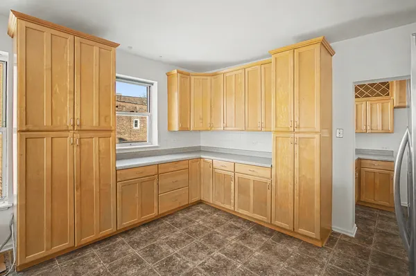 a kitchen with stainless steel appliances a refrigerator sink and cabinets