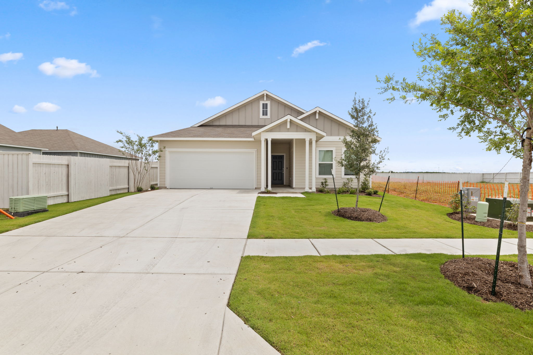 2460 Winding Creek Road Kyle, TX 78640 - Photo 1 of 20 A welcoming front exterior with a wide driveway and neatly maintained lawn.