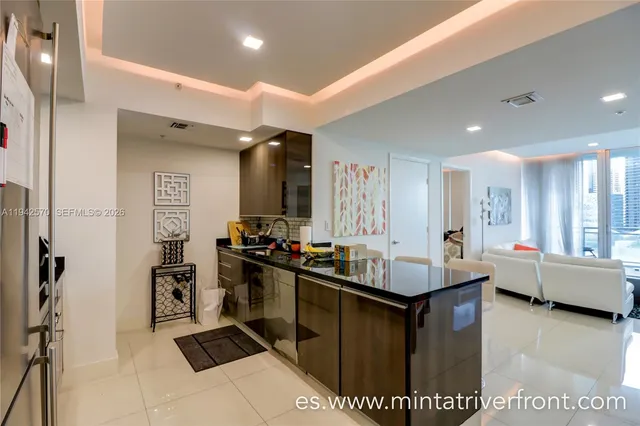 a kitchen with kitchen island granite countertop a stove and a sink