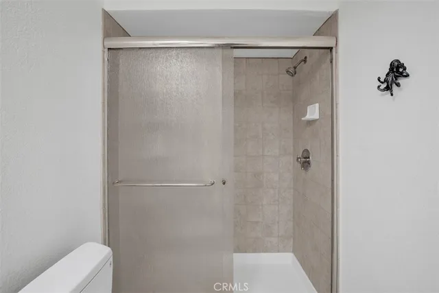 a bedroom with a bed and a night stand