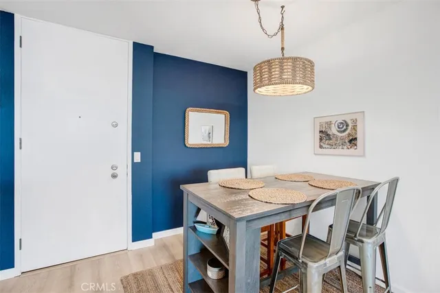 a kitchen with granite countertop kitchen island stainless steel appliances a stove a sink a living table and chairs