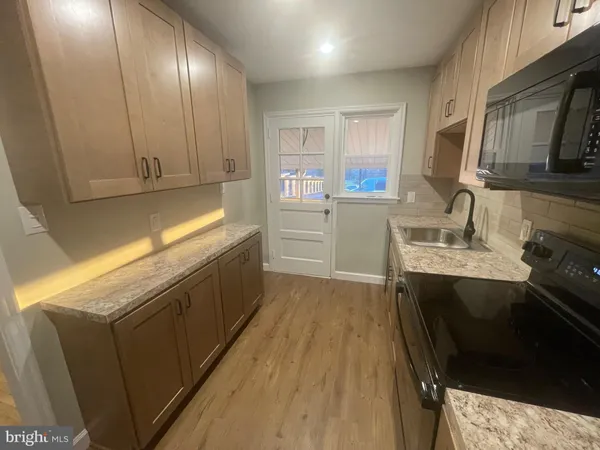 a kitchen with a sink stove and cabinets