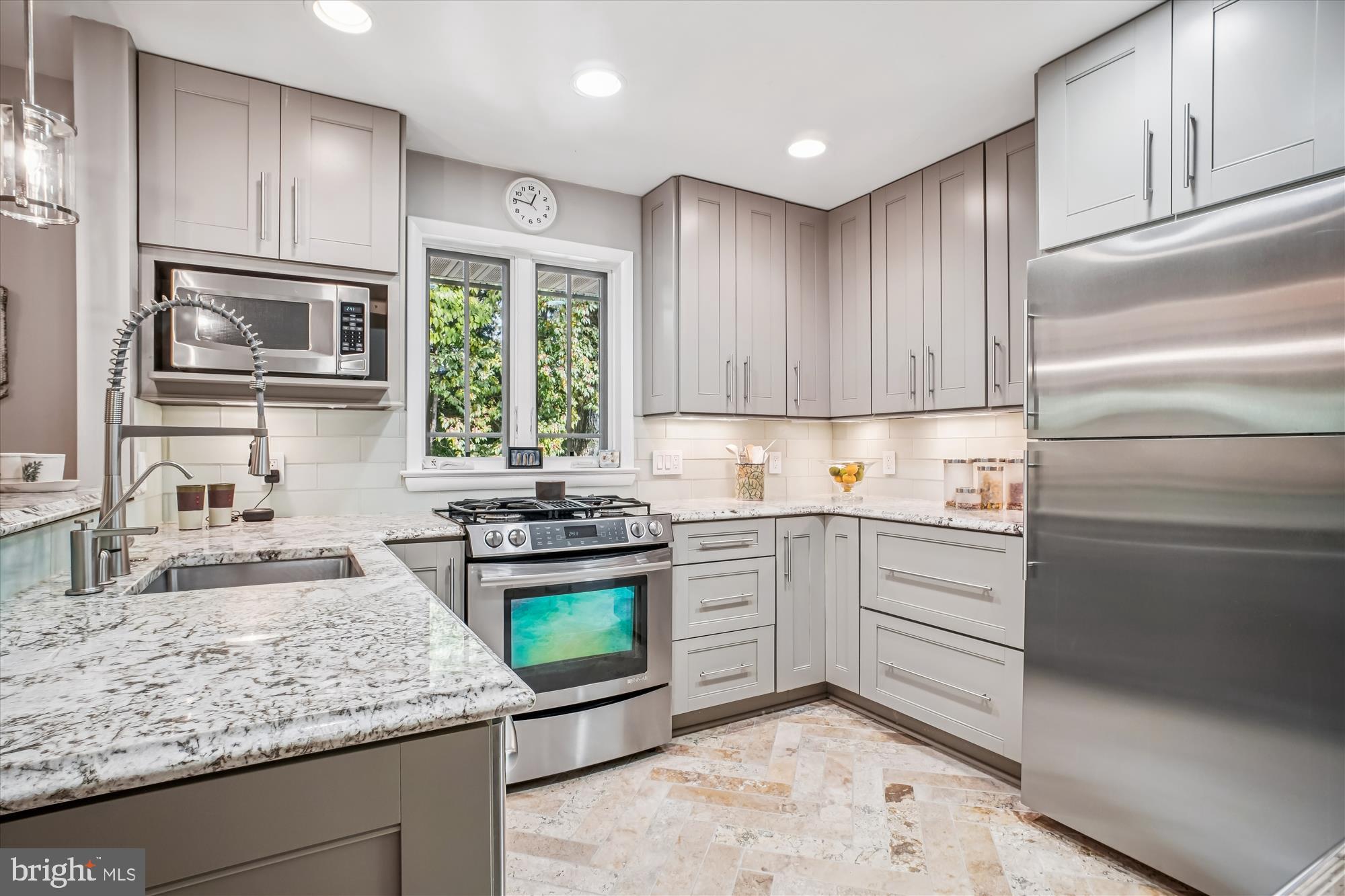3717 Chanel Road Annandale, VA 22003 - Photo 15 of 57 a kitchen with stainless steel appliances granite countertop a sink stove and cabinets