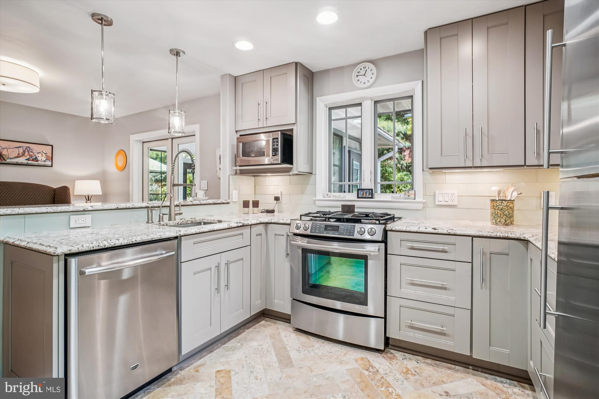 3717 Chanel Road Annandale, VA 22003 - Photo 16 of 57 a kitchen with kitchen island granite countertop a stove sink and microwave