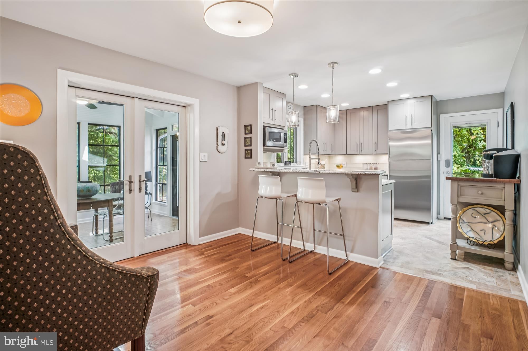 3717 Chanel Road Annandale, VA 22003 - Photo 18 of 57 a kitchen with stainless steel appliances granite countertop a refrigerator a stove top oven and a dining table with wooden floor
