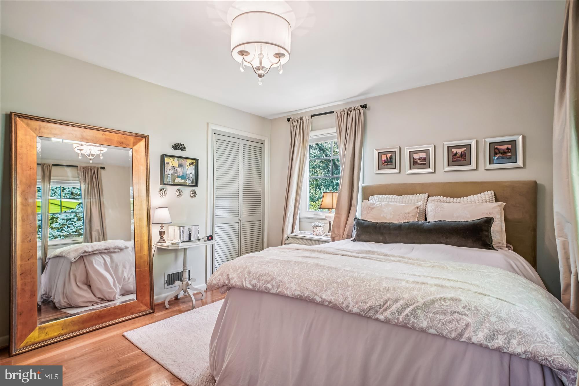 3717 Chanel Road Annandale, VA 22003 - Photo 21 of 57 a bedroom with a large bed and a chandelier