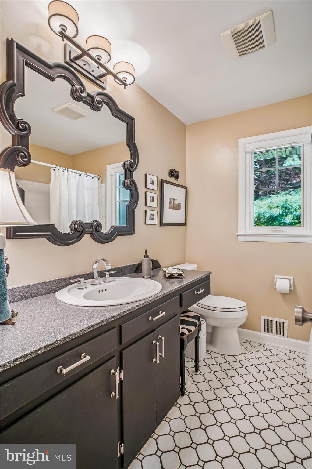 3717 Chanel Road Annandale, VA 22003 - Photo 24 of 57 a bathroom with a toilet sink and mirror
