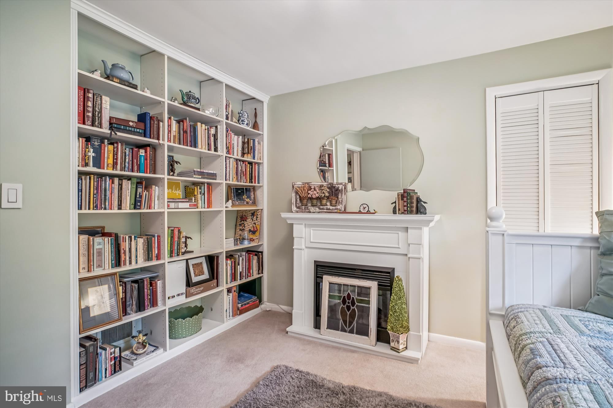 3717 Chanel Road Annandale, VA 22003 - Photo 30 of 57 a living room with a bookshelf and a fireplace
