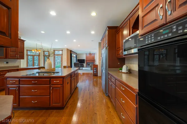 a kitchen with stainless steel appliances granite countertop a stove a sink and a refrigerator