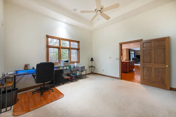 a view of a livingroom with workspace and a window