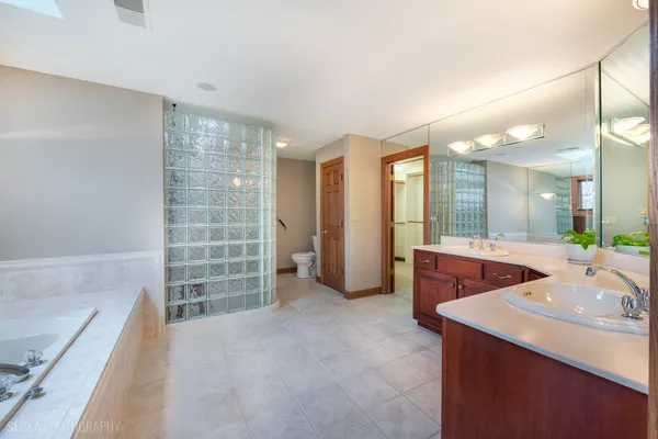 a spacious bathroom with a double vanity sink and a mirror