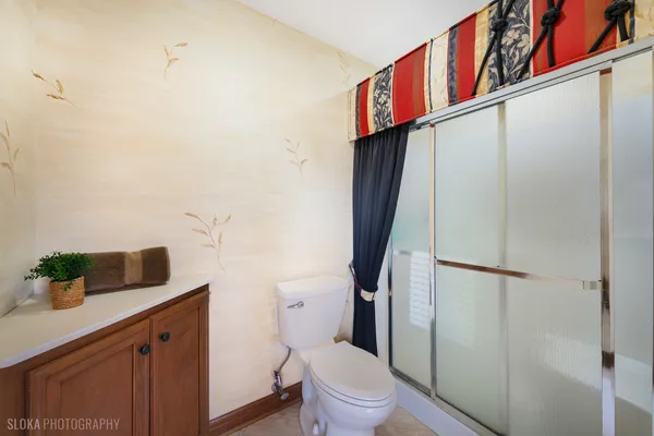 a bathroom with a toilet sink and shower