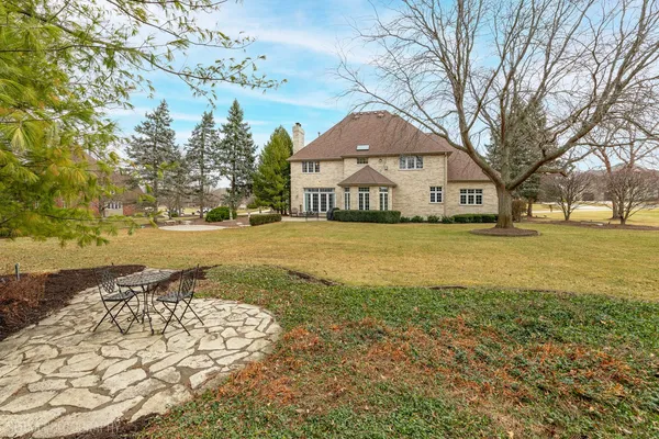 a view of a white house with a yard