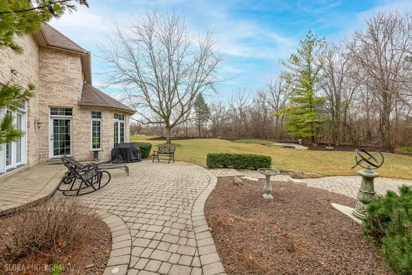 a view of a backyard with table and chairs and a fire pit