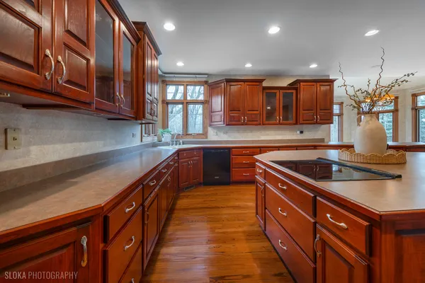 a kitchen with stainless steel appliances granite countertop a sink and a stove