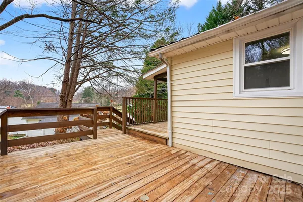a view of a roof deck with wooden floor and fence